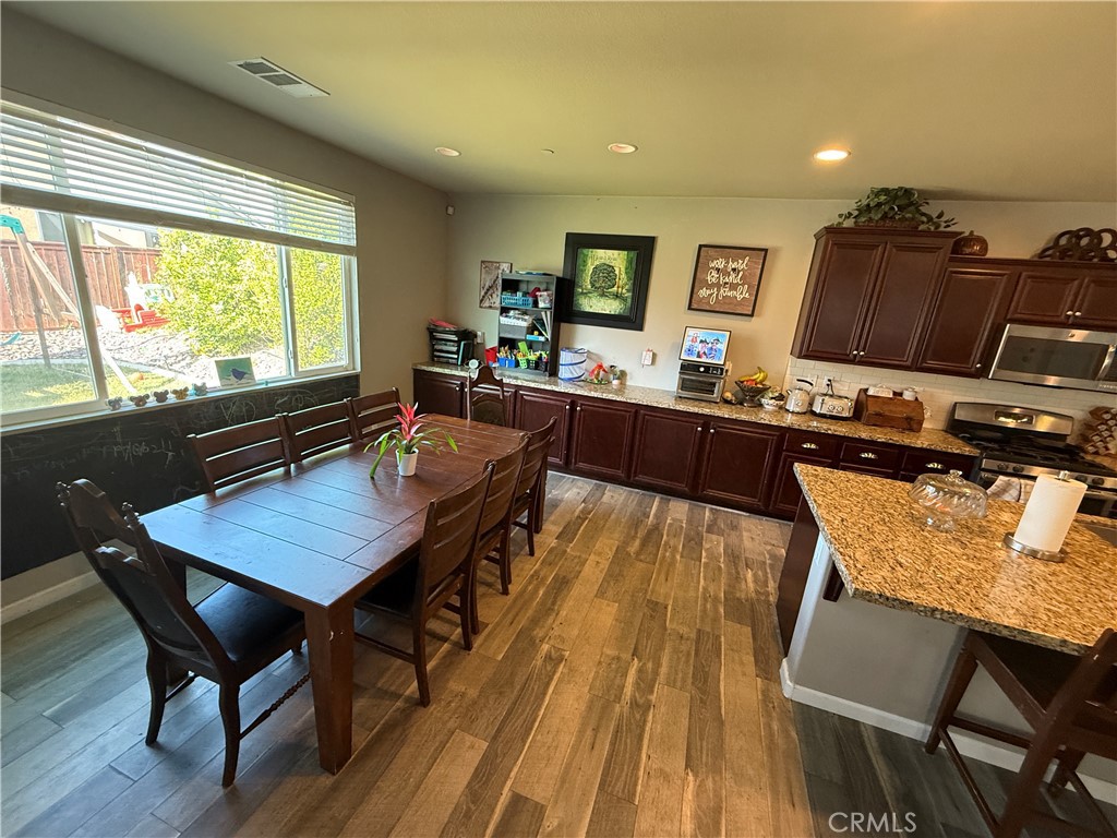 30130 Pine Needle Road Menifee, CA 92585 - Photo 18 of 45 a dining room with furniture and wooden floor