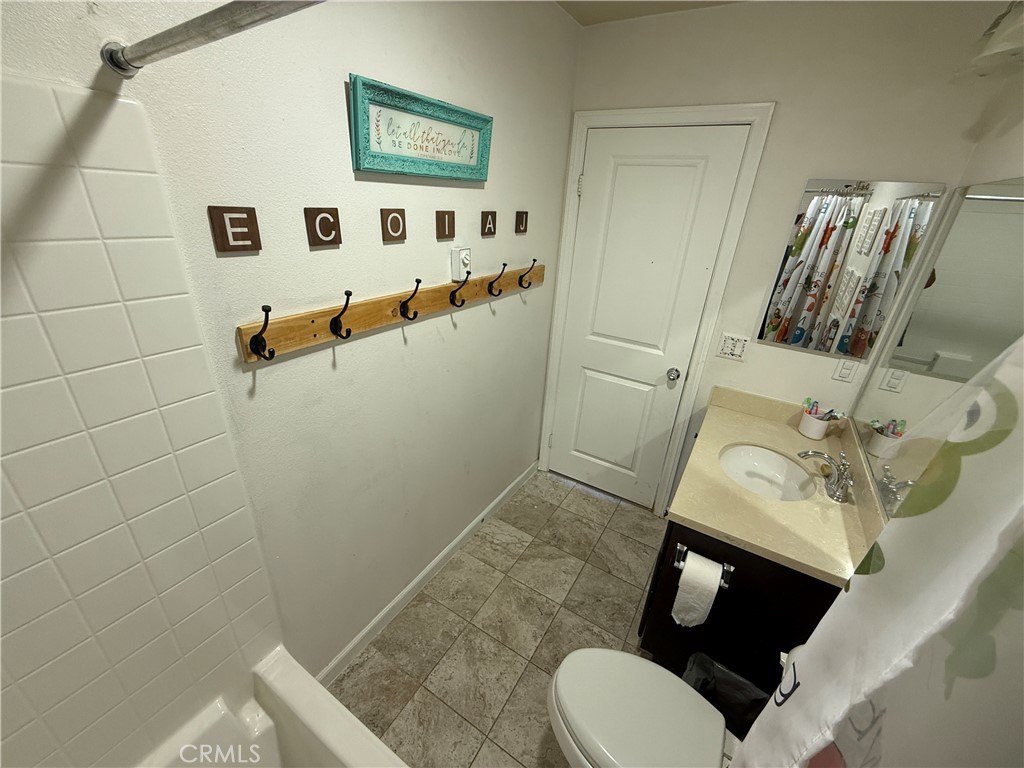 30130 Pine Needle Road Menifee, CA 92585 - Photo 21 of 45 a bathroom with a sink and mirror with toilet