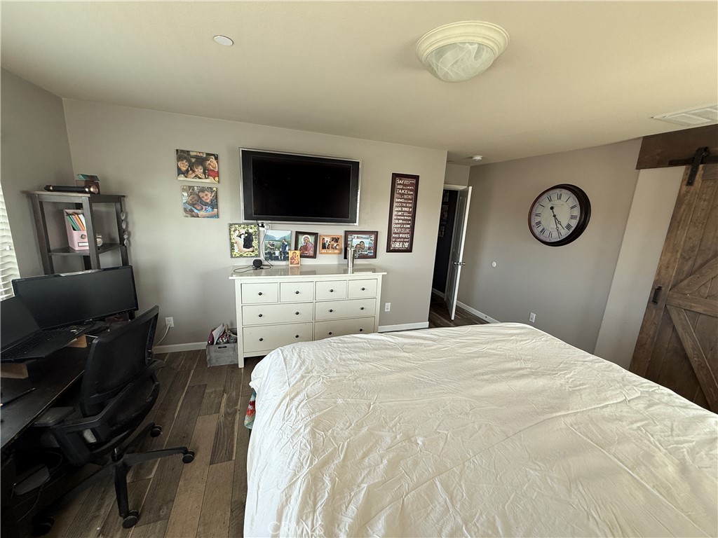 30130 Pine Needle Road Menifee, CA 92585 - Photo 25 of 45 a bedroom with a bed and a flat screen tv
