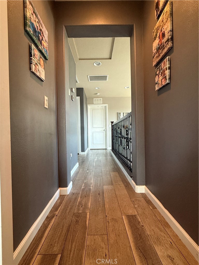 30130 Pine Needle Road Menifee, CA 92585 - Photo 30 of 45 a view of a hallway with wooden floor