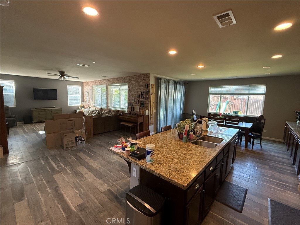 30130 Pine Needle Road Menifee, CA 92585 - Photo 32 of 45 a view of a dining room with furniture a rug and wooden floor