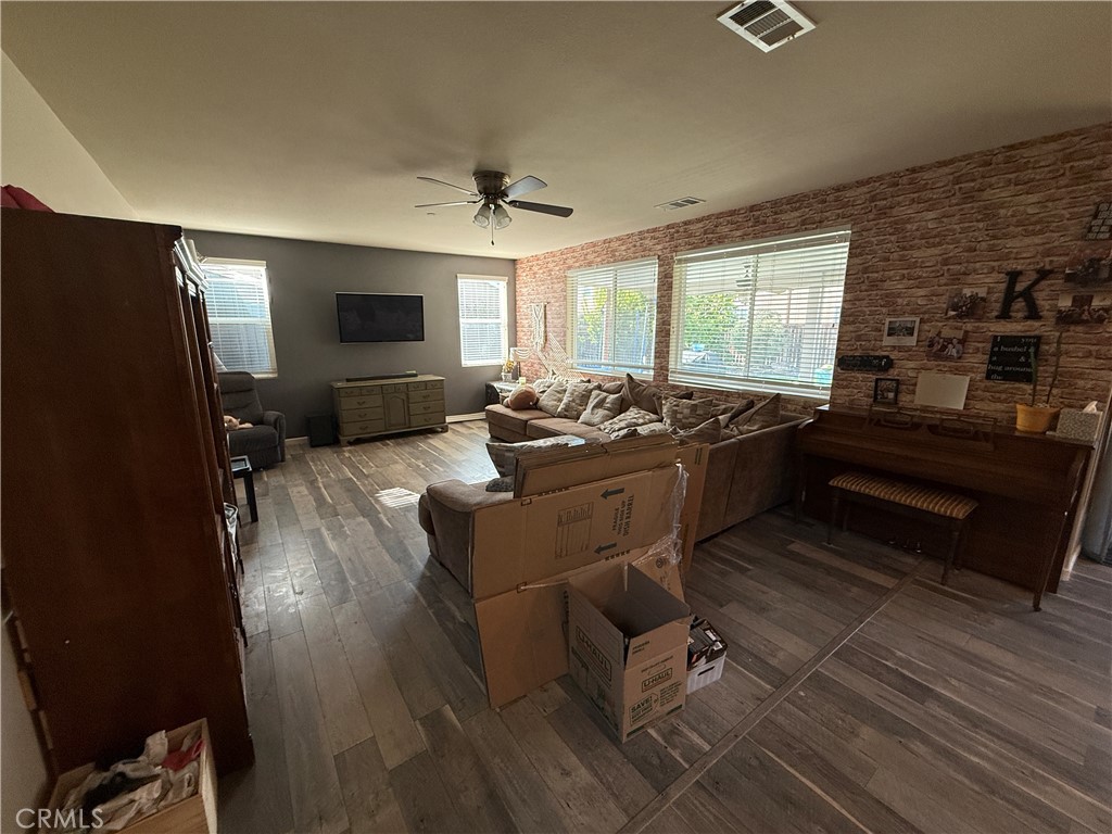 30130 Pine Needle Road Menifee, CA 92585 - Photo 35 of 45 a living room with furniture and a flat screen tv
