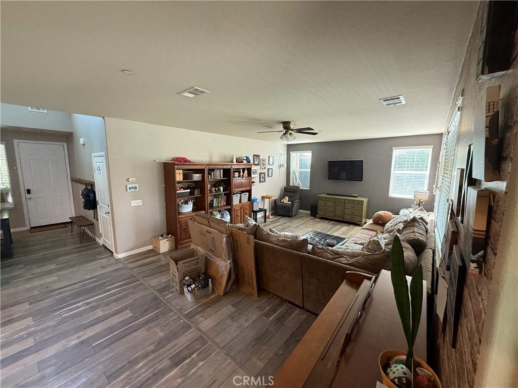 30130 Pine Needle Road Menifee, CA 92585 - Photo 38 of 45 a kitchen with stainless steel appliances granite countertop a sink stove and wooden floor