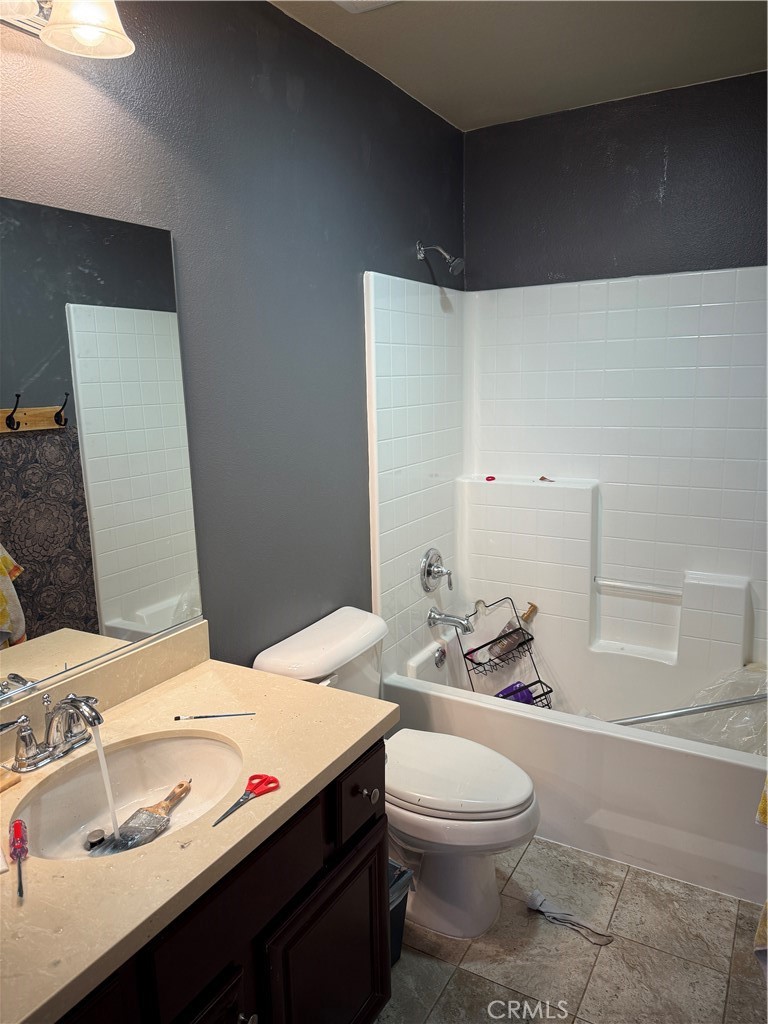30130 Pine Needle Road Menifee, CA 92585 - Photo 40 of 45 a bathroom with a sink a toilet and shower