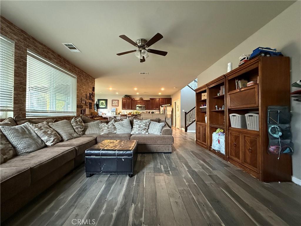 30130 Pine Needle Road Menifee, CA 92585 - Photo 5 of 45 a living room with furniture and a wooden floor