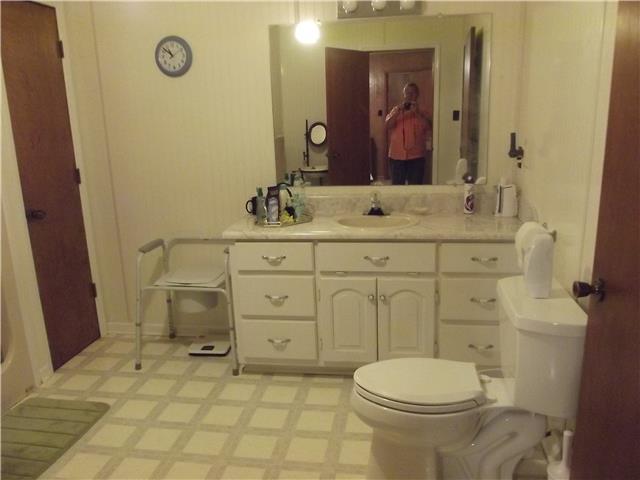 896 Solomon Road Pulaski, TN 38478 - Photo 11 of 20 a bathroom with a sink a toilet and mirror