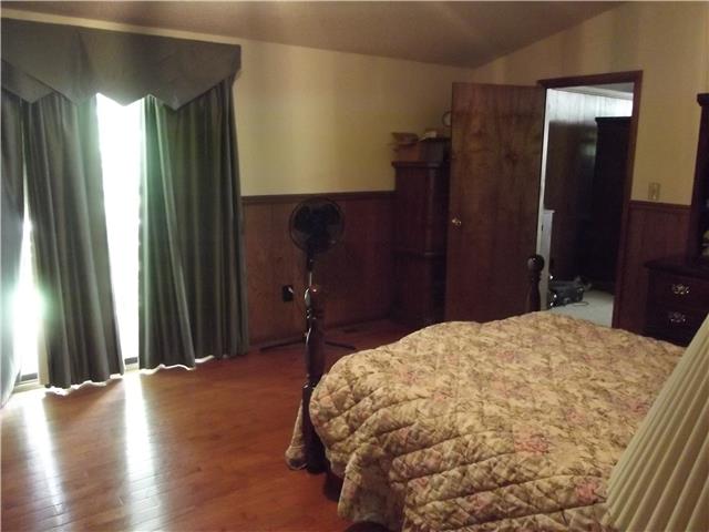 896 Solomon Road Pulaski, TN 38478 - Photo 20 of 20 a bedroom with a bed and wooden floor