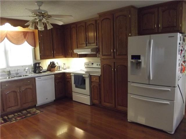 896 Solomon Road Pulaski, TN 38478 - Photo 4 of 20 a kitchen with granite countertop stainless steel appliances and wooden cabinets
