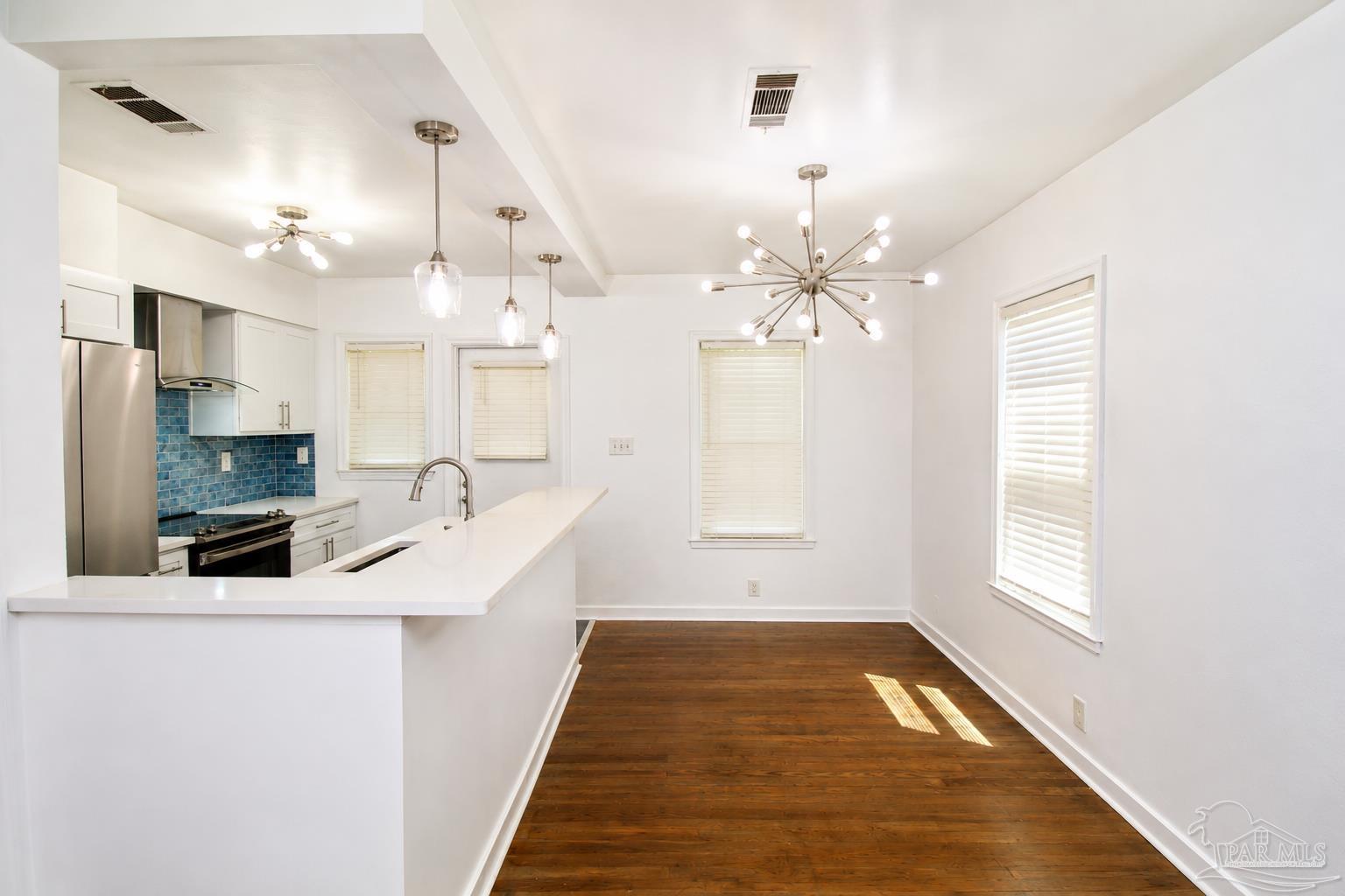 315 Flannan Road Pensacola, FL 32507 - Photo 6 of 17 a view of a kitchen with a sink and dishwasher with wooden floor
