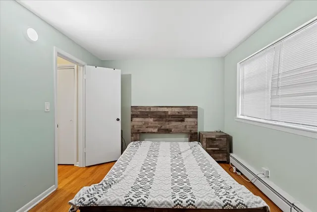 a bed sitting in a bedroom next to a window