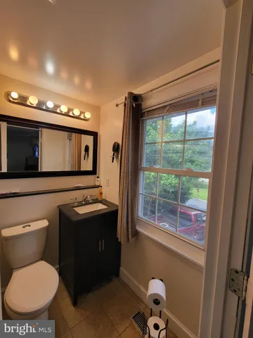 a bathroom with a toilet sink and mirror