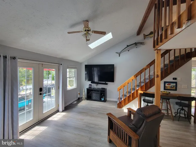 a living room with furniture flat screen tv and a fireplace
