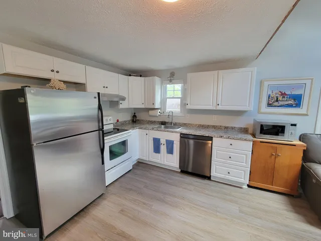 a kitchen with stainless steel appliances a refrigerator stove and sink