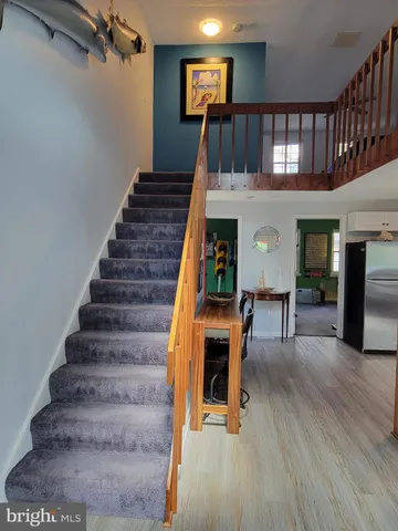 a view of entryway dining room and hall with wooden floor