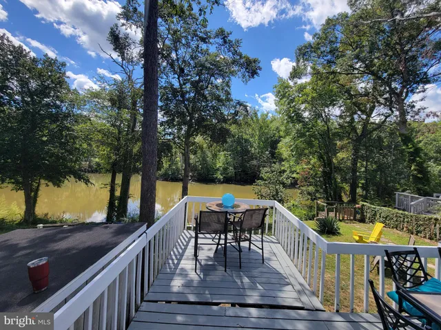 a view of deck with furniture and trees