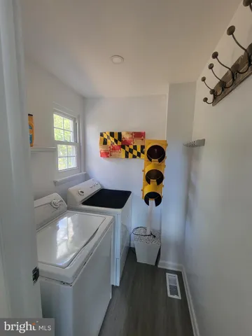 a bathroom with a sink toilet and window