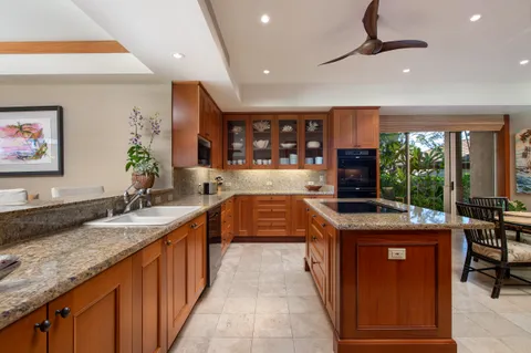 a kitchen with kitchen island a large counter top space appliances and a counter top space