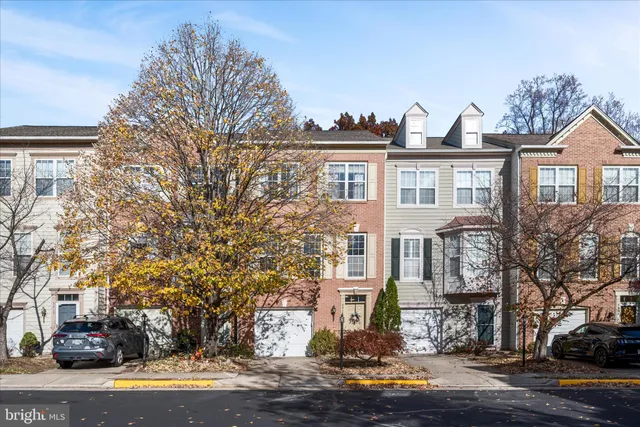 a front view of a residential apartment building with a yard