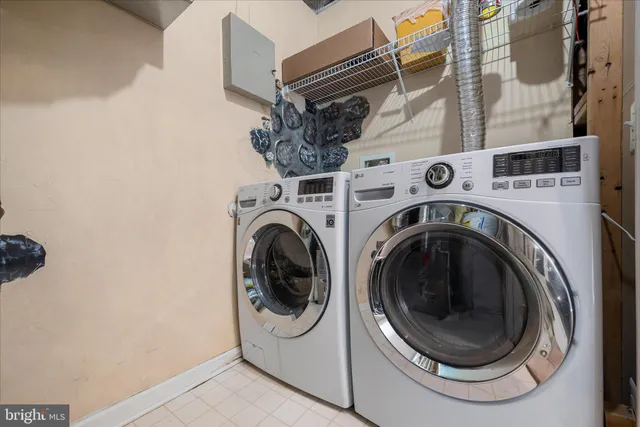 a kitchen with stainless steel appliances granite countertop a stove top oven a sink dishwasher and a refrigerator with wooden floor