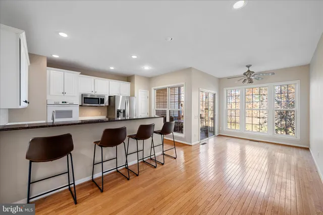 a kitchen with white cabinets sink and stainless steel appliances
