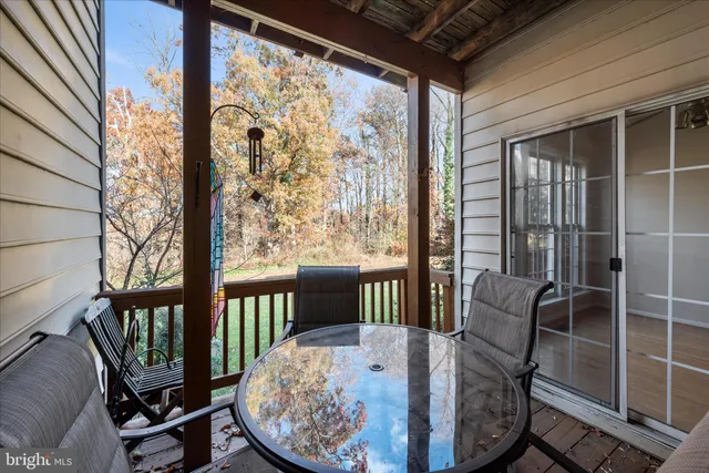 a view of a hallway with wooden floor and stairs