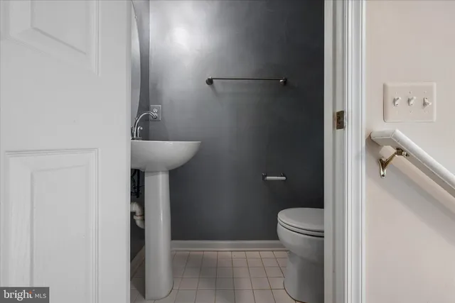 a bathroom with a granite countertop sink a toilet and a mirror