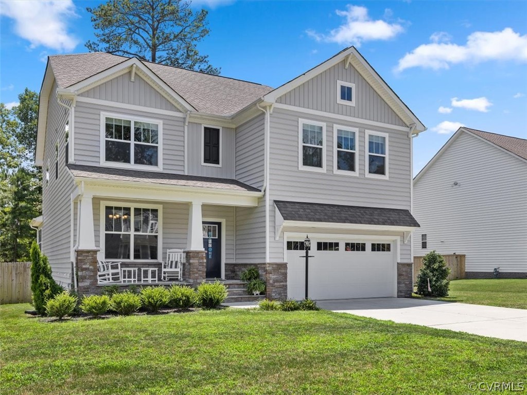 1413 Braisden Road Midlothian, VA 23114 - Photo 1 of 37 a front view of a house with a yard and garage
