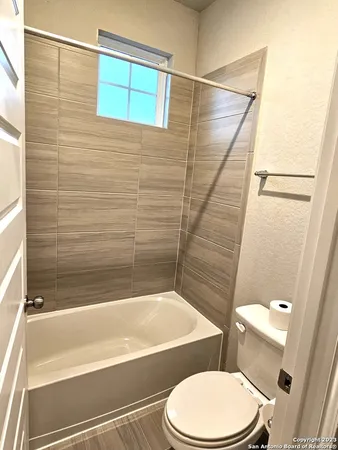 a bathroom with a toilet and a bathtub