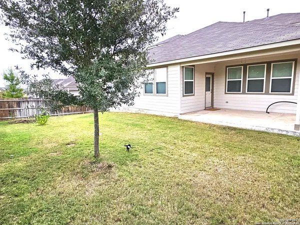 a view of a house with a yard and swimming pool
