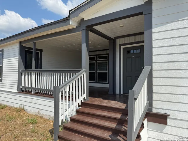 a view of a living room a refrigerator and a stove