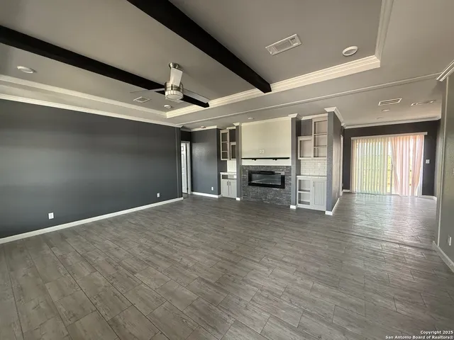 a kitchen with stainless steel appliances kitchen island granite countertop a refrigerator and a stove top oven