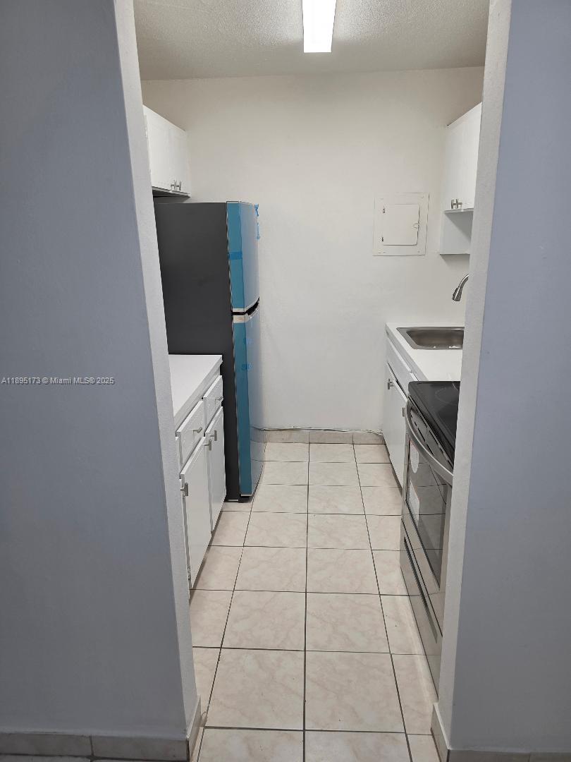 677 Southwest 9th Avenue, Unit 205 Miami, FL 33130 - Photo 10 of 27 a bathroom with a sink and a washer dryer