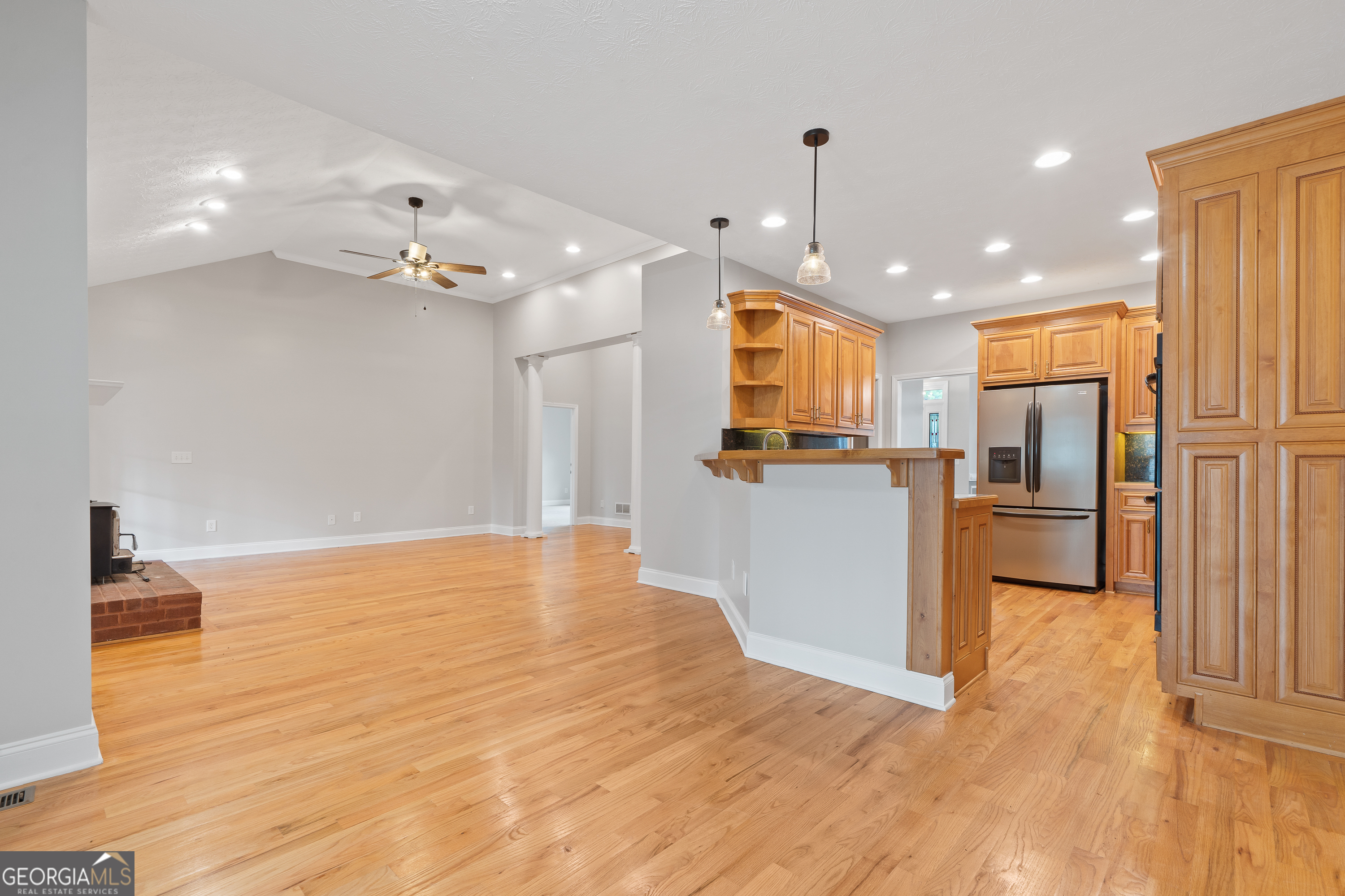 1041 Holstein Road Buckhead, GA 30625 - Photo 13 of 49 a view of a kitchen with a refrigerator a ceiling fan and wooden floor