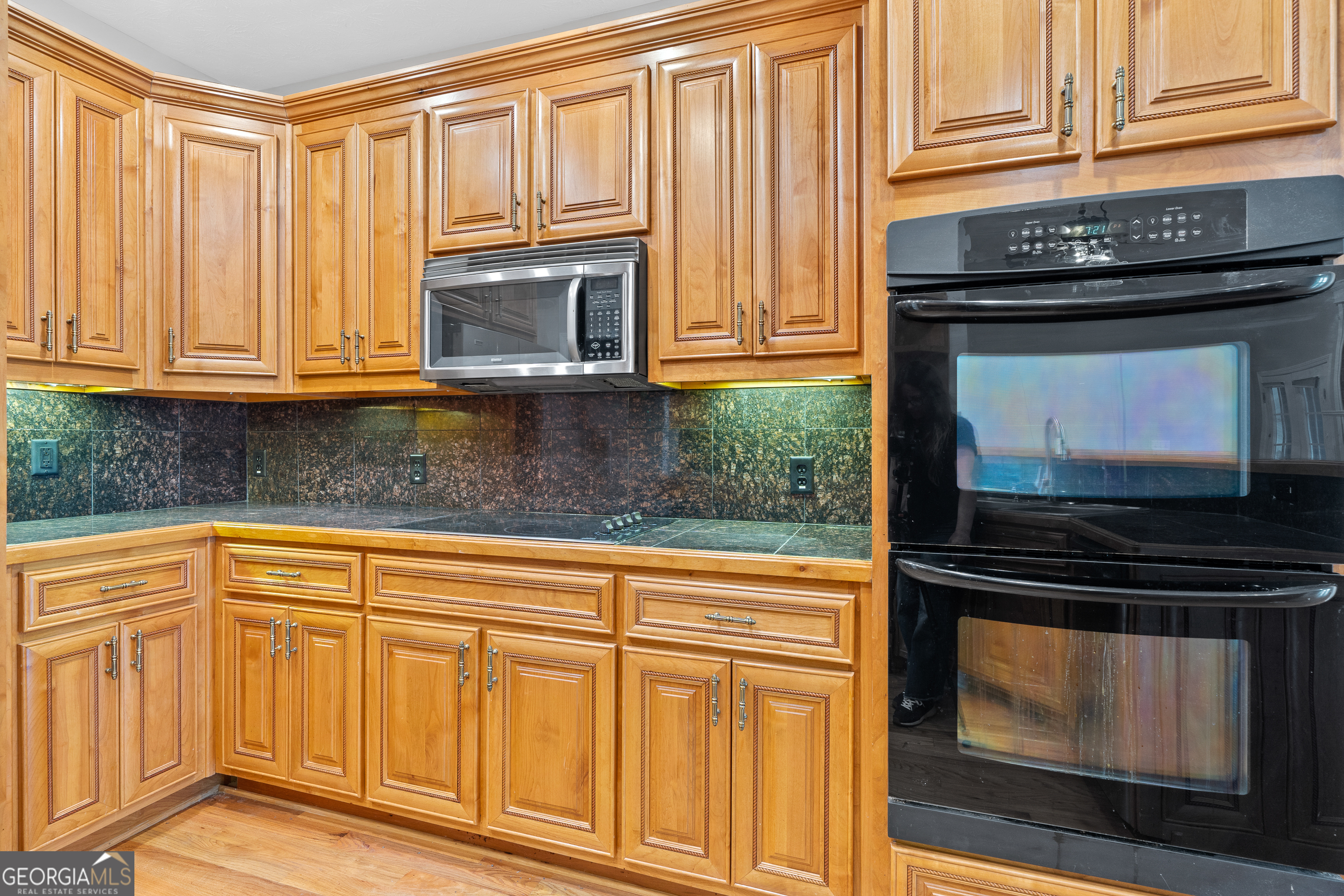 1041 Holstein Road Buckhead, GA 30625 - Photo 16 of 49 a kitchen with granite countertop cabinets and black appliances