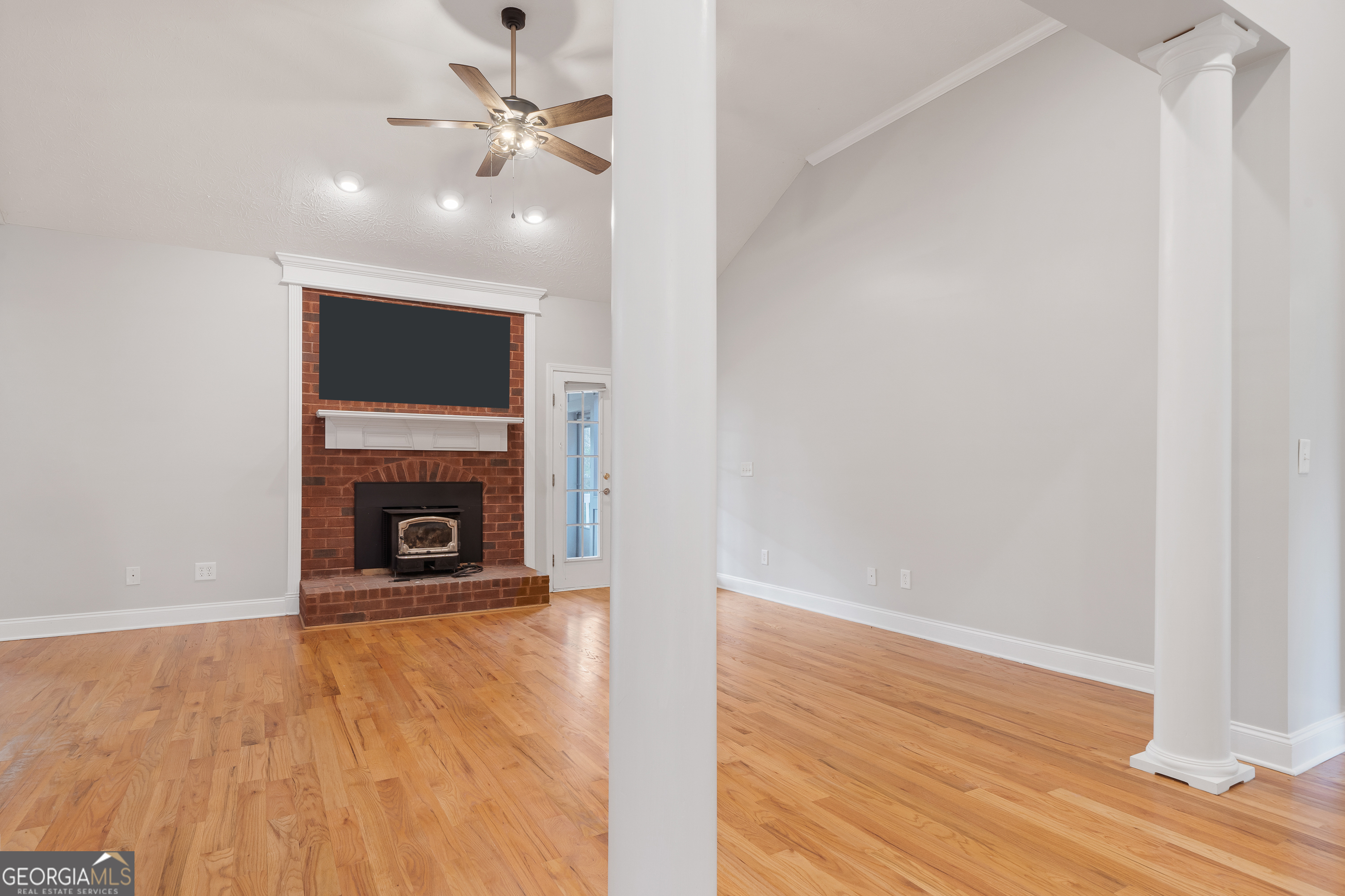 1041 Holstein Road Buckhead, GA 30625 - Photo 9 of 49 a view of a livingroom with a fireplace a ceiling fan and wooden floor