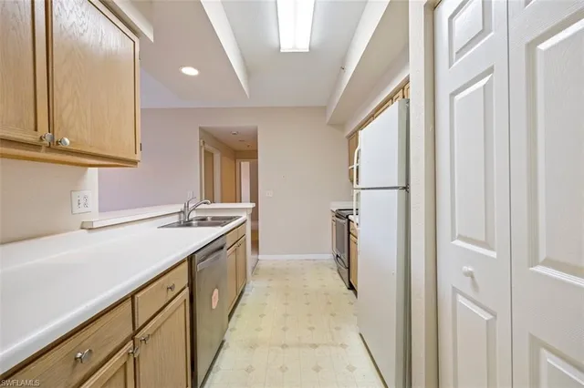 a kitchen with a sink and refrigerator