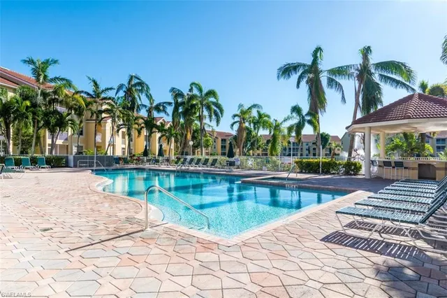 a view of swimming pool with outdoor seating and plants
