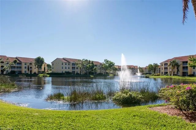 a view of a lake with houses in the back