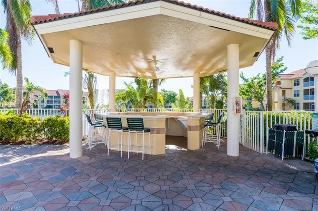 a view of a patio with table and chairs and potted plants