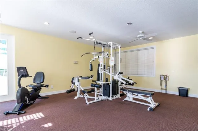 a room with gym equipment and windows