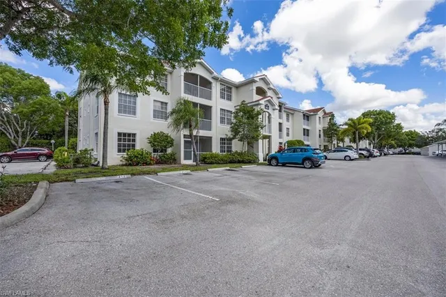 a view of road with card parked on side and road