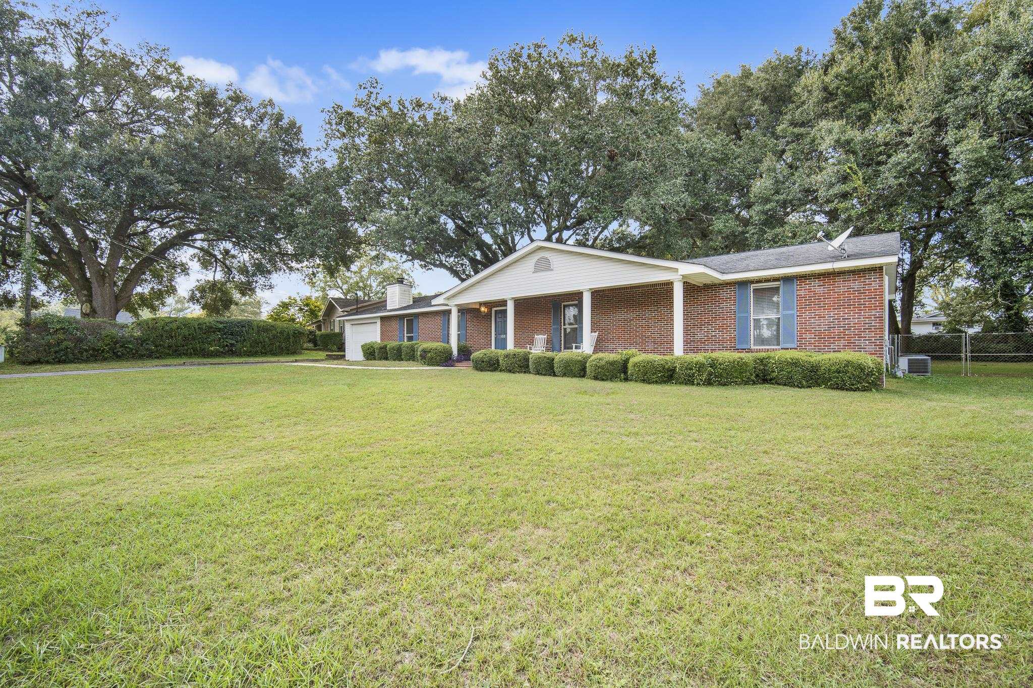 103 Ann Street Daphne, AL 36527 - Photo 2 of 23 Ranch-style house featuring brick siding, a garage, covered porch, and a chimney