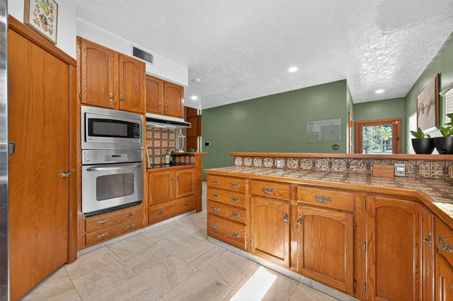 a kitchen with stainless steel appliances granite countertop a stove and a sink