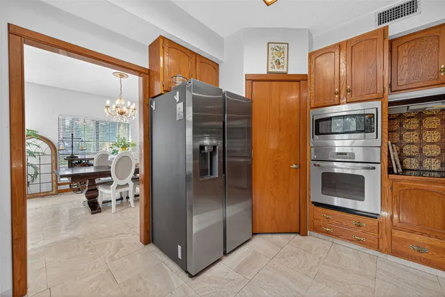 a kitchen with stainless steel appliances granite countertop a refrigerator and a stove