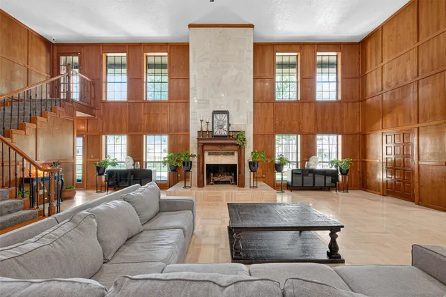 a living room with furniture a fireplace and window