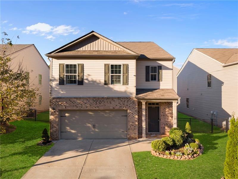 a front view of a house with a garden and plants