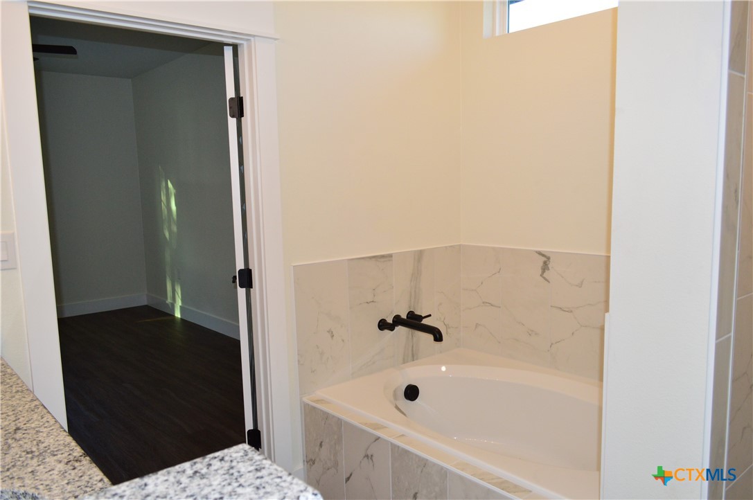 425 County Road 3152 Kempner, TX 76539 - Photo 28 of 48 a bathroom with a tub and shower
