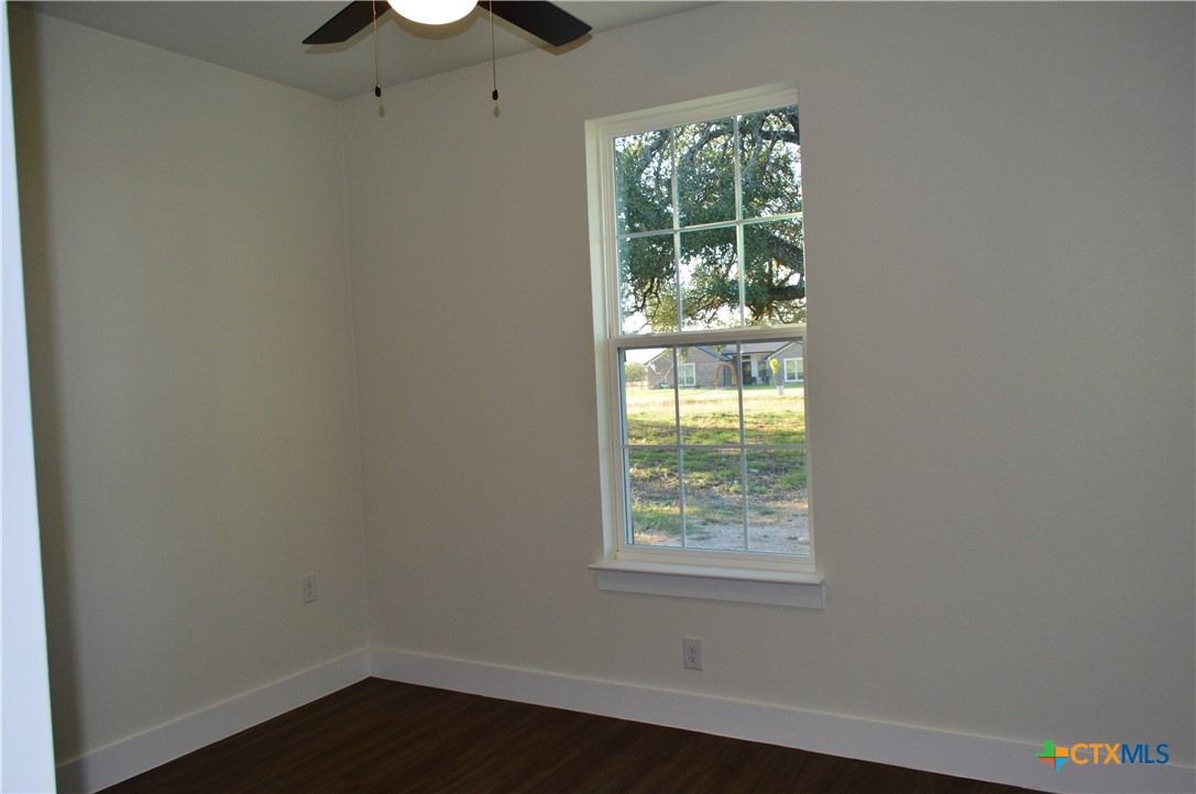425 County Road 3152 Kempner, TX 76539 - Photo 30 of 48 an empty room with wooden floor and windows