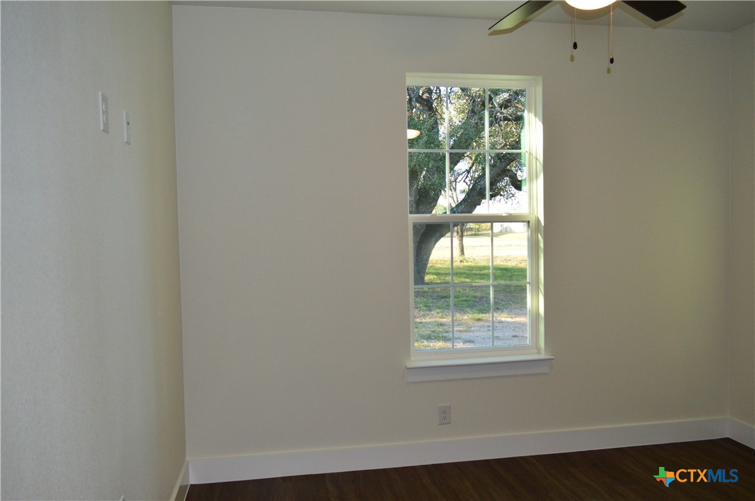 425 County Road 3152 Kempner, TX 76539 - Photo 31 of 48 an empty room with wooden floor fan and windows