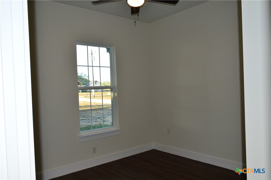 425 County Road 3152 Kempner, TX 76539 - Photo 32 of 48 a view of an empty room with wooden floor and a window